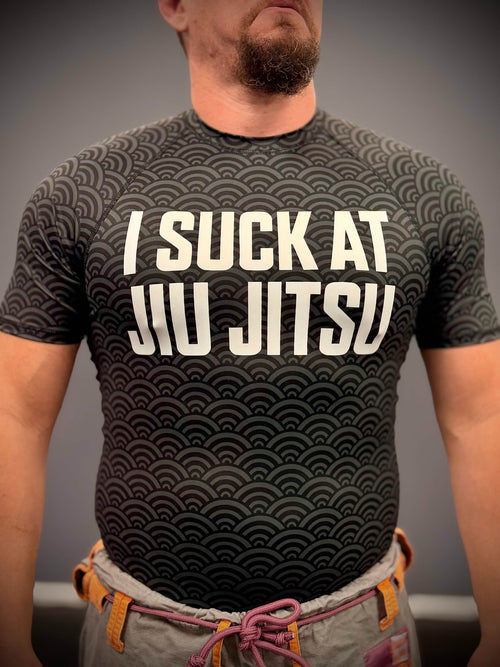 Front view of Mat Theory I Suck at Jiu Jitsu rashguard