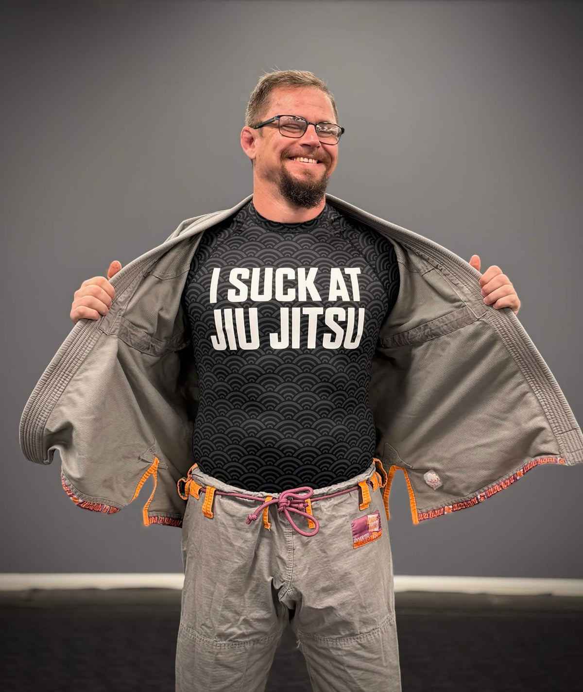 Mat Theory I Suck at Jiu Jitsu rashguard under a gi